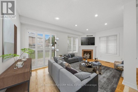 A modern living room with a grey sofa and a wooden coffee table.