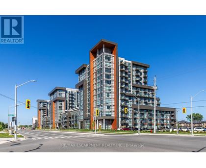 A modern multi-story building with a glass facade and a wooden top.