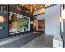 A hallway with a large map on the wall and a bench on the right side.