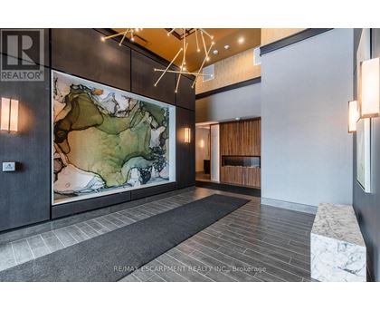 A hallway with a large map on the wall and a bench on the right side.
