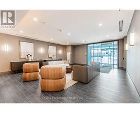 A spacious living room with a grey floor and a white ceiling.