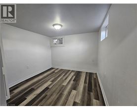 A room with wooden flooring and a window.