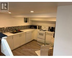 A kitchen with white cabinets and a blue countertop.