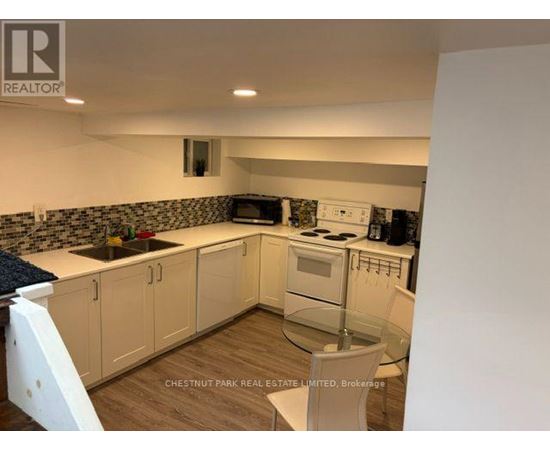 A kitchen with white cabinets and a blue countertop.