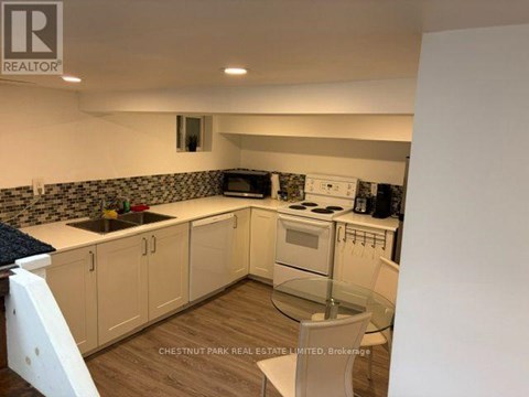 A kitchen with white cabinets and a blue countertop.