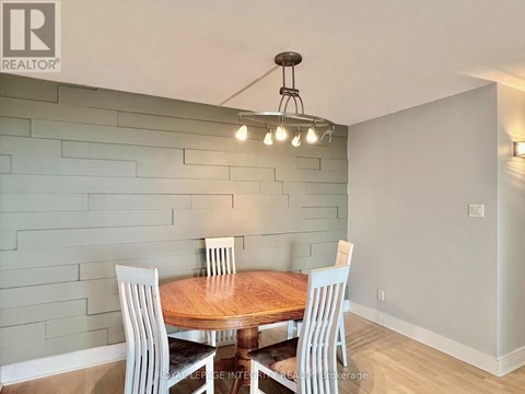 A dining room with a wooden table and chairs.
