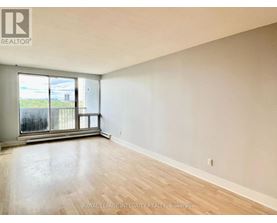 A room with a large window and wooden flooring.