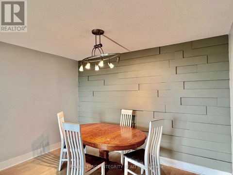 A dining room with a wooden table and chairs.