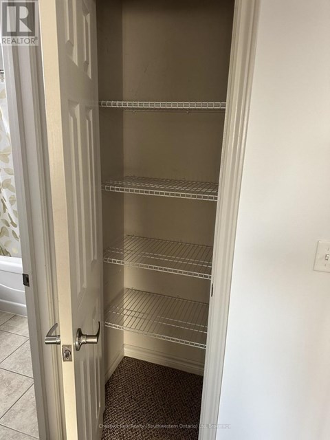 A white door with a handle and a sign that says REALTOR.