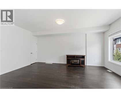 A spacious living room with a wood-burning stove in the corner.