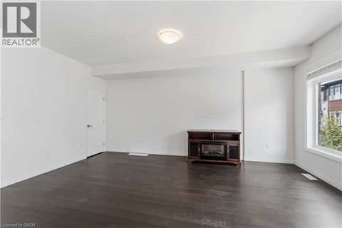 A spacious living room with a wood-burning stove in the corner.