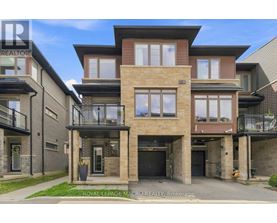 A modern two-story house with a balcony on the second floor.