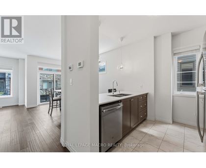 A kitchen with a stainless steel dishwasher and a sink.