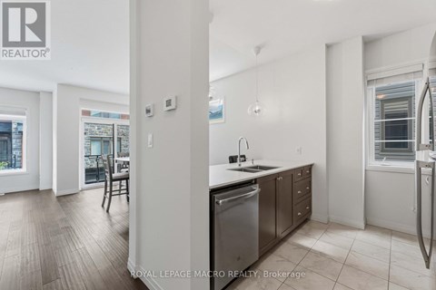 A kitchen with a stainless steel dishwasher and a sink.