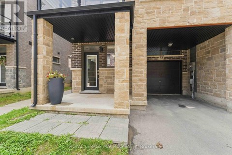 A stone building with a black door and windows.