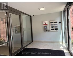 The entrance to Intercity Realty Inc. Brokerage with a glass door and a black doormat.