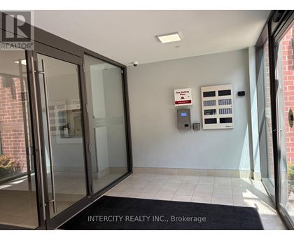 The entrance to Intercity Realty Inc. Brokerage with a glass door and a black doormat.