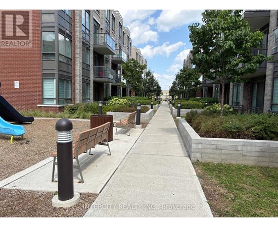 A walkway between two buildings with a sign that says "Invercity Realty Inc Brokerage".