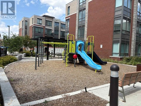 A playground with a blue slide and a yellow slide.