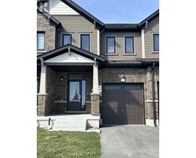 A two-story house with a black front door and a garage.
