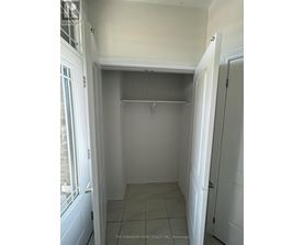 A white hallway with a door on the right.