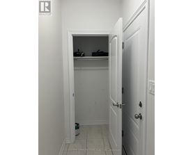A white door is open to a small closet.