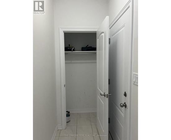 A white door is open to a small closet.