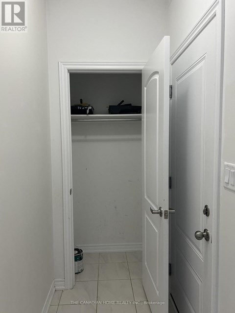 A white door is open to a small closet.