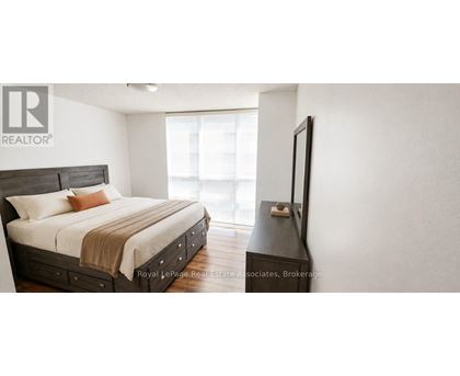 A bedroom with a bed, dresser and a window.