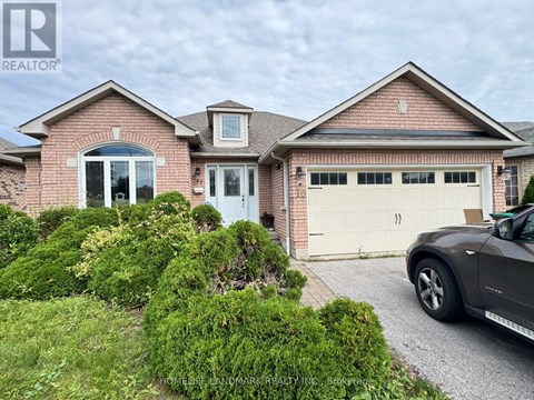 A house with a grey car parked in front.