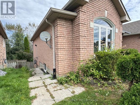 A brick house with a satellite dish on the roof.