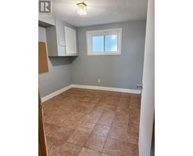 A room with tile flooring and a window.