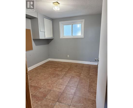 A room with tile flooring and a window.