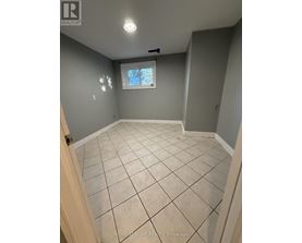 A room with tile flooring and a window.