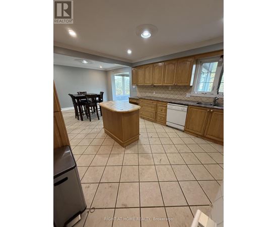 A kitchen with a dining table and chairs.
