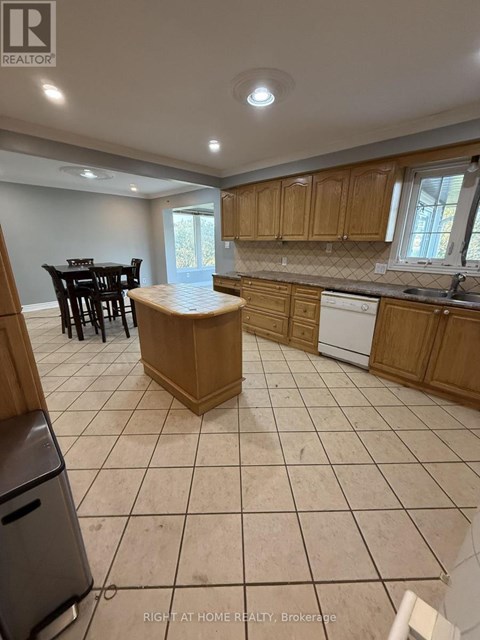 A kitchen with a dining table and chairs.