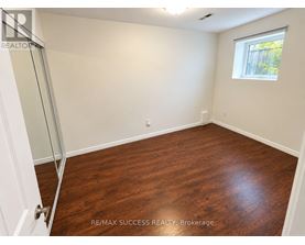 A room with a wooden floor and a window.