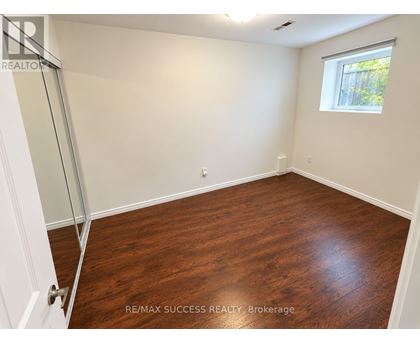 A room with a wooden floor and a window.