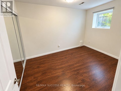 A room with a wooden floor and a window.