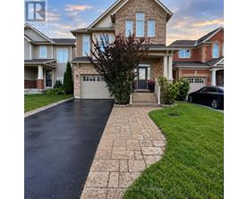 A house with a driveway and a car parked in front.
