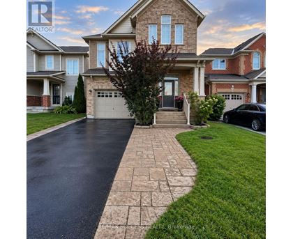 A house with a driveway and a car parked in front.