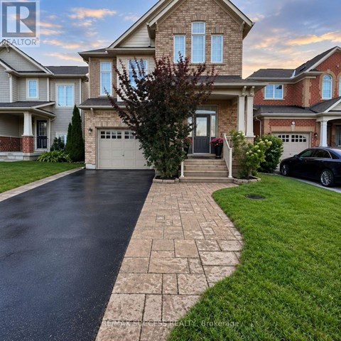 A house with a driveway and a car parked in front.