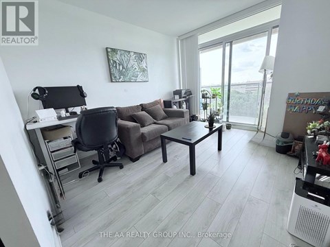 A living room with a couch, chair, and desk.
