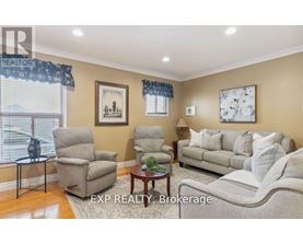 A living room with a couch, chairs, and a coffee table.