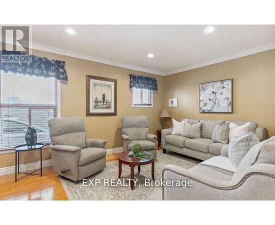 A living room with a couch, chairs, and a coffee table.