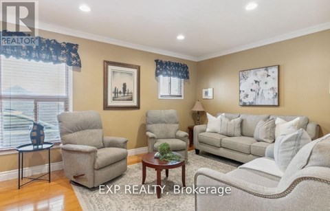A living room with a couch, chairs, and a coffee table.