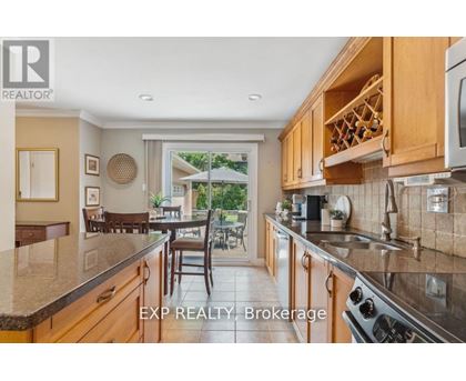 A kitchen with wooden cabinets and a stainless steel stove.
