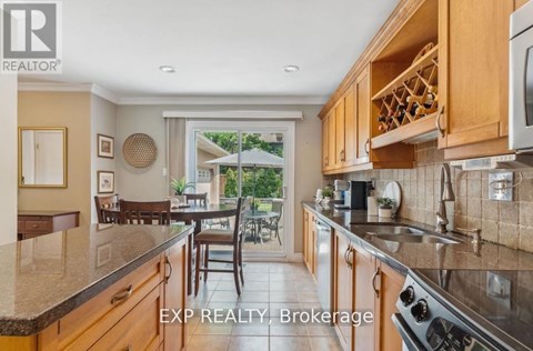 A kitchen with wooden cabinets and a stainless steel stove.