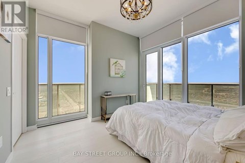 A bedroom with a large bed and a view of the beach.