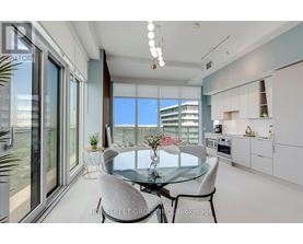A modern dining room with a glass table and chairs.